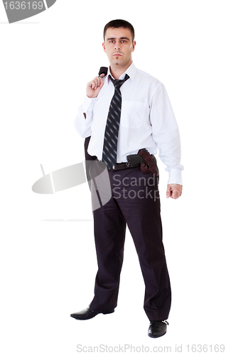 Image of young man in black suit with gun