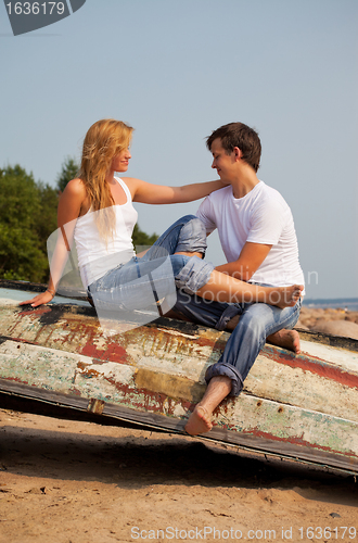 Image of young couple on old boat