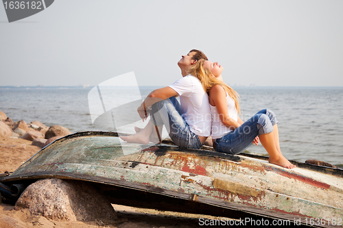 Image of couple sitting on old boat