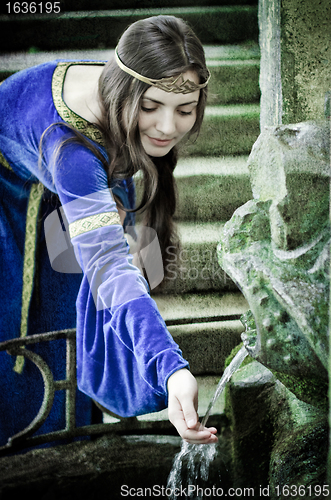 Image of medieval girl next ancient spring