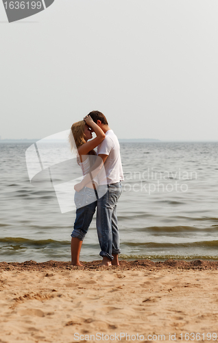 Image of couple embrace on a beach