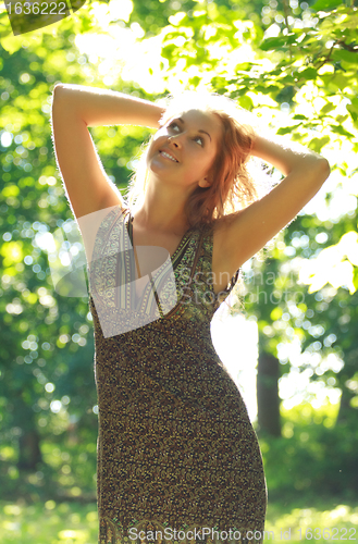 Image of beautiful girl in sunshine rays