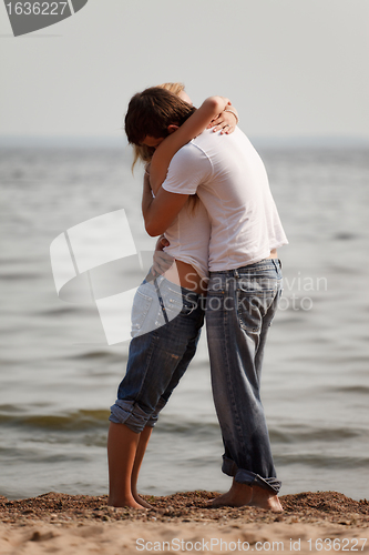 Image of couple embrace on a beach