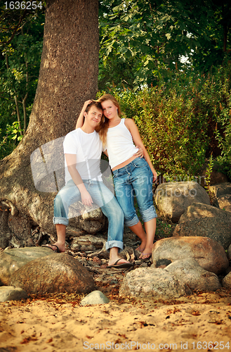 Image of smiling couple next tree