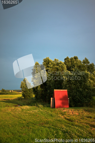 Image of wooden cabin on meadow