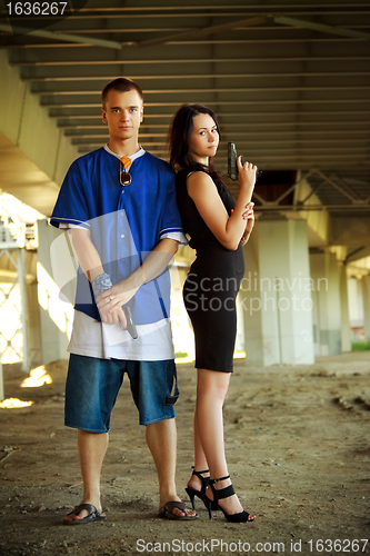 Image of young couple with guns