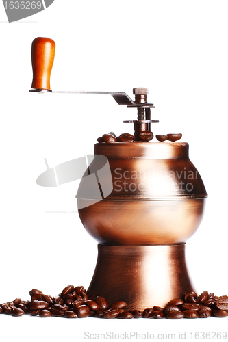 Image of vintage coffee grinder standing on beans