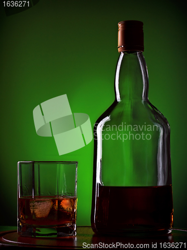 Image of whiskey and glass on wooden tray