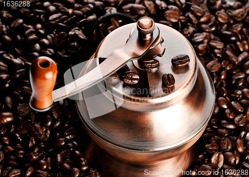 Image of vintage coffee mill in beans
