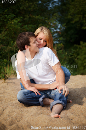 Image of couple sitting on a sand