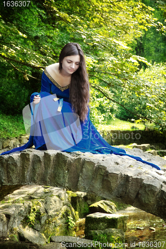 Image of medieval princess on stone bridge