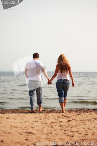 Image of couple walking on a beach