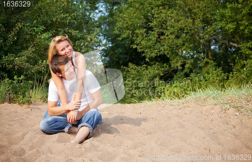 Image of couple sitting on a sand