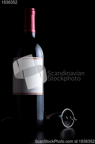 Image of bottle of red wine and corkscrew