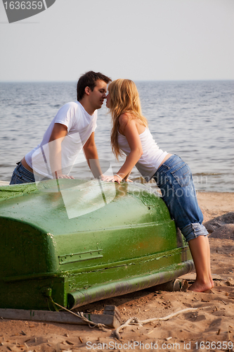 Image of beautiful couple kissing on a beach