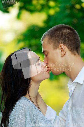 Image of kissing couple in the park