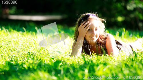 Image of beautiful girl laying on meadow