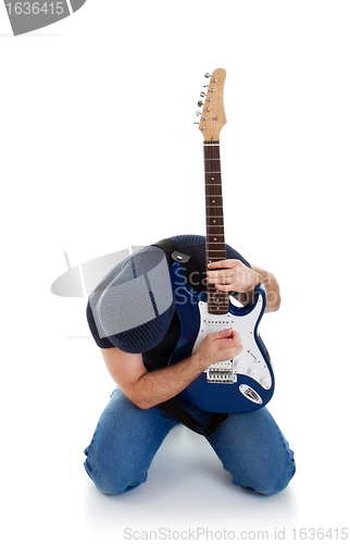 Image of rocker playing guitar kneeling