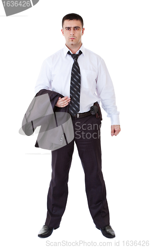 Image of young man in black suit with gun