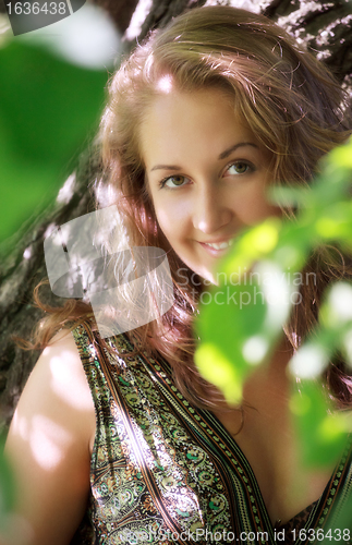 Image of girl standing in shadow of leaves