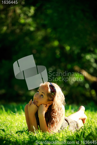 Image of girl laying on sunny meadow