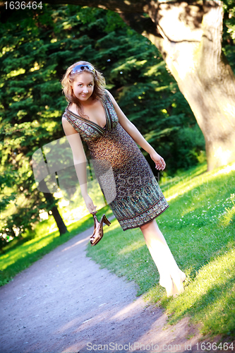 Image of girl walk on park lawn