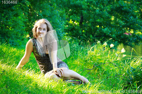 Image of beautyful woman sitting on riverside