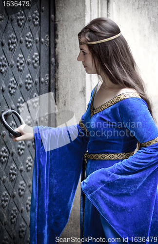 Image of medieval girl opening door