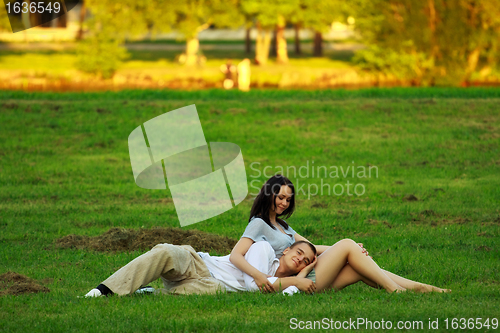 Image of couple laying on park lawn