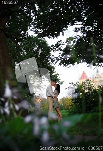 Image of kissing couple in the park
