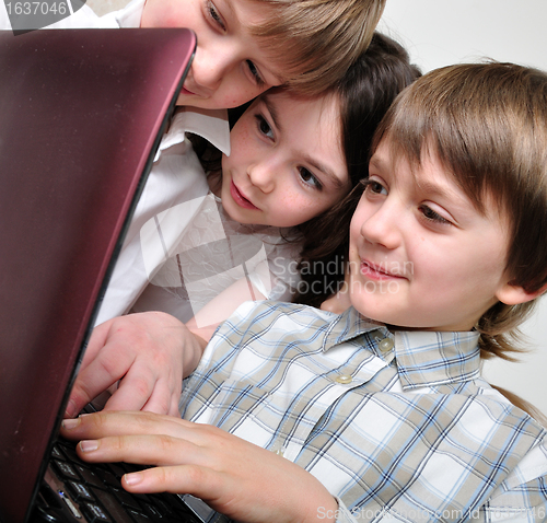 Image of group of children friends playing computer games