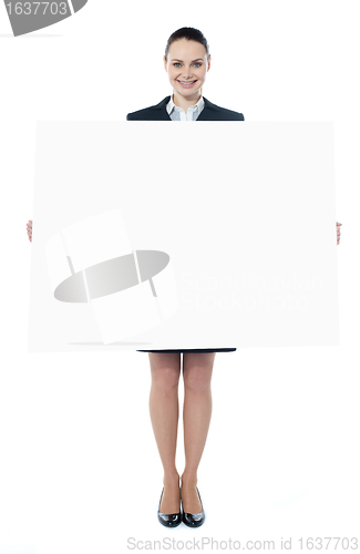 Image of Confident young executive with an advertising board