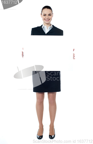 Image of Caucasian businesswoman holding a blank billboard