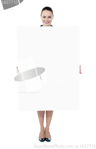Image of Young woman holding blank billboard
