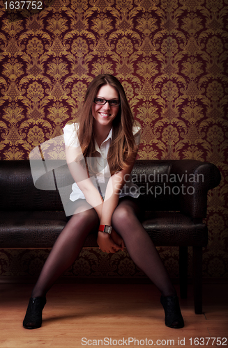 Image of girl sitting on sofa