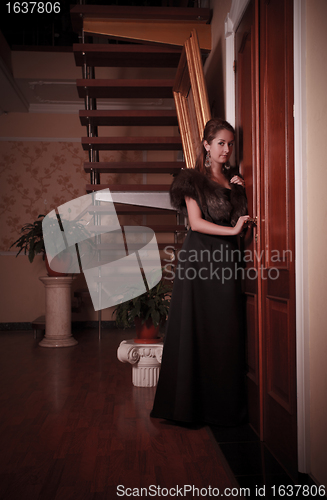 Image of lady eavesdropping near closed door