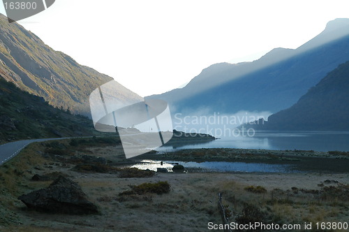 Image of Sunrise over misty lake