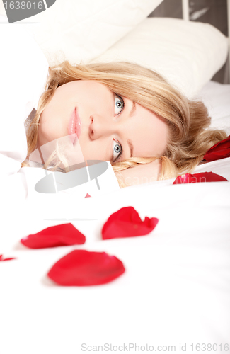 Image of Woman In Bed With Rose Petals