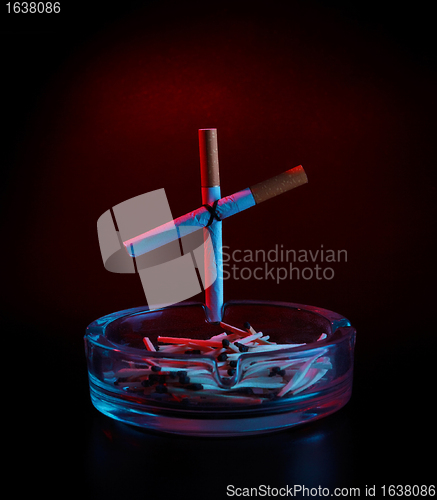 Image of cigarette cross on ashtray