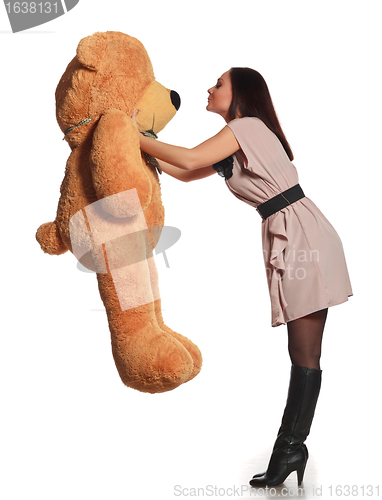 Image of beautiful girl kissing toy bear