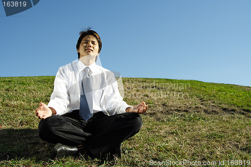 Image of Businessman meditating