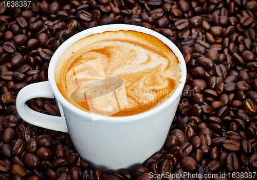 Image of espresso cup in coffee beans