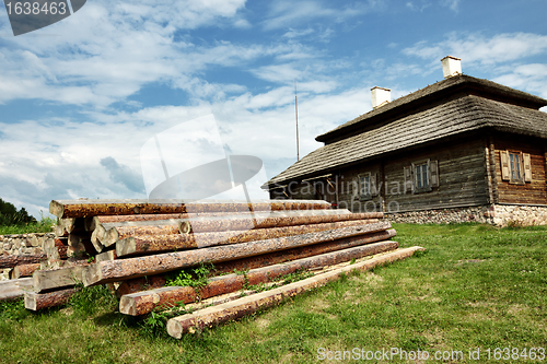 Image of wooden cottage on green hill