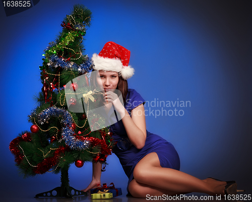 Image of girl lay near christmas tree