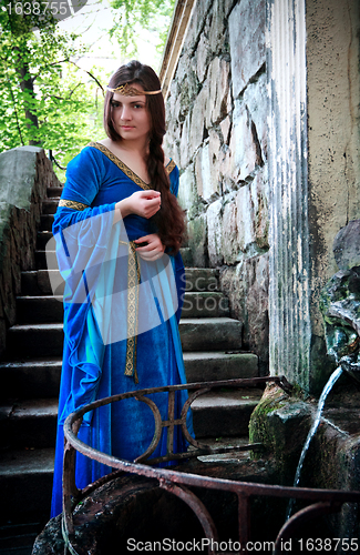 Image of medieval girl next ancient spring