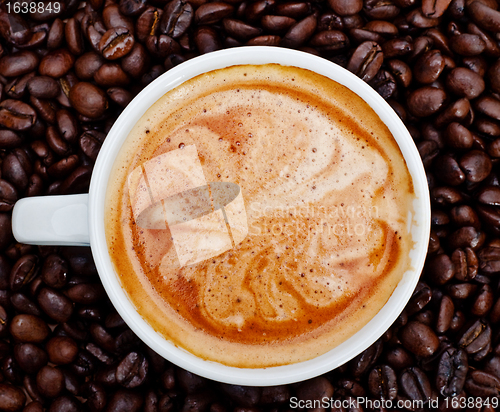 Image of espresso cup in coffee beans