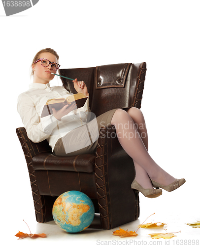 Image of female teacher sitting in armchair