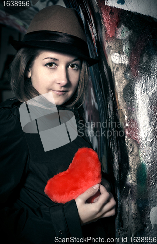 Image of sad girl with toy heart