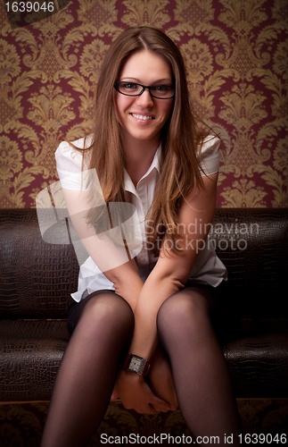 Image of girl sitting on sofa