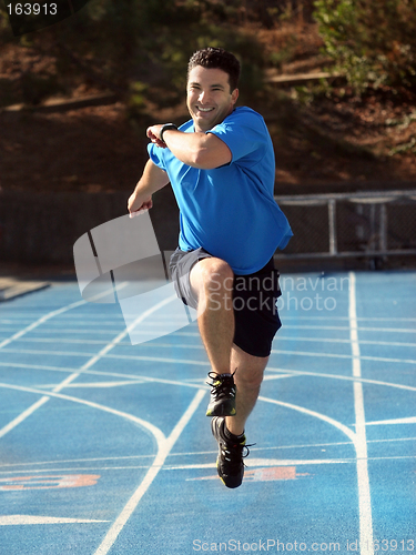 Image of Man running  on a blue racetrack